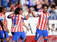 Atletico Madrid's Raul Garcia (R) is congratulates by teammates after scoring against Granada, on April 14, 2013